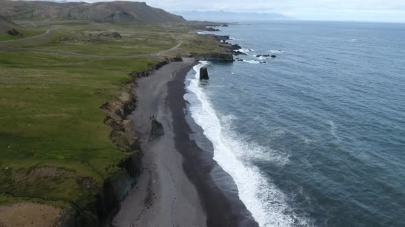 Drone view of black sand beach at Atlantic ocean in Iceland alt