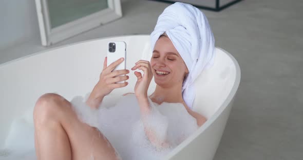 Beautiful Sexy Woman Lying Naked in Bathtub Full of Foam in White Home Bathroom Enjoying Beauty Day alt