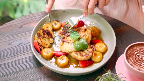 Breakfast in Cafe  Woman Hand Cutting Piece of Sweet Caramel Toasted Bread alt