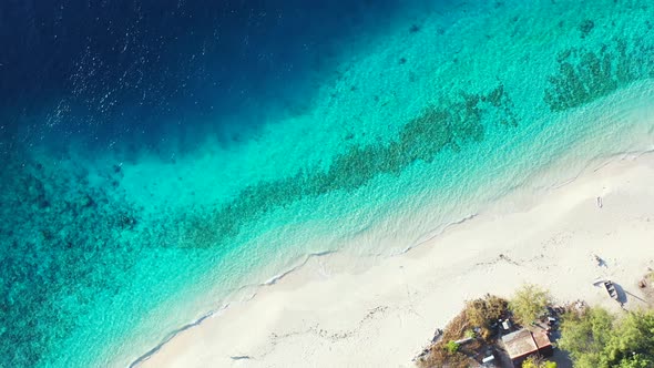 Idyllic exotic beach with secluded white sand washed by blue turquoise lagoon with coral reefs and p alt