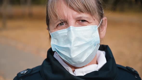 Portrait of a Senior Woman in a Respirator Protection Mask