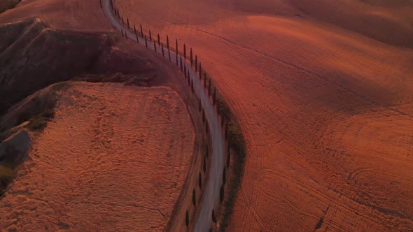 Aerial shot of a biker traveling in Val d'orcia ,TUSCANY,ITALY alt