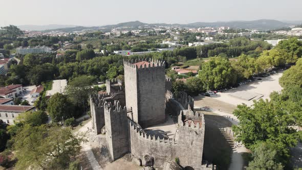 Guimaraes castle close up, aerial establishing shot of medieval Romanesque structure