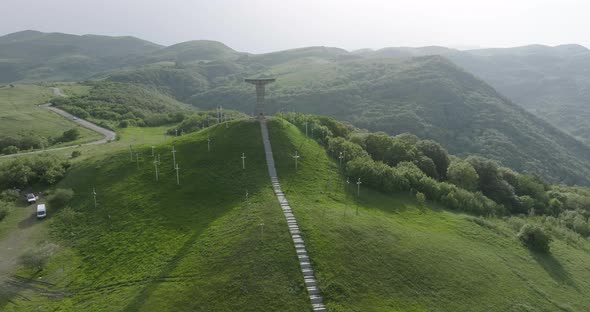 Aerial dolly out shot of Didgori Valley landscape, monument and amphitheater. alt