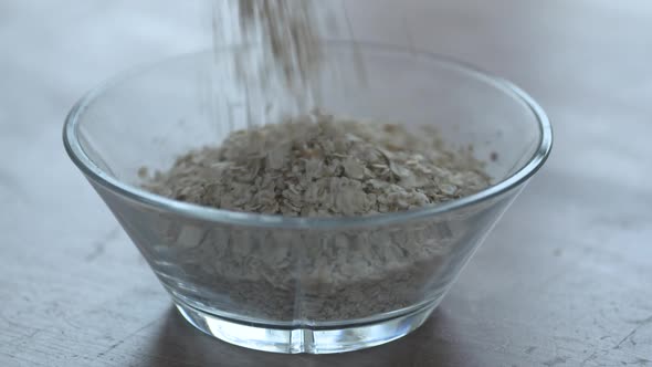 Oat Meal Pouring Oatmeal In A Glass Bowl in superslow motion