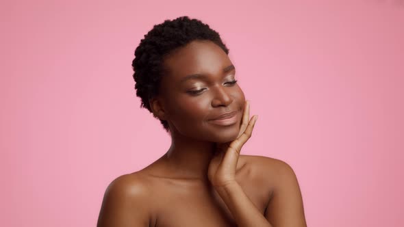 Sensual African Female Stroking Chest And Neck On Pink Background alt