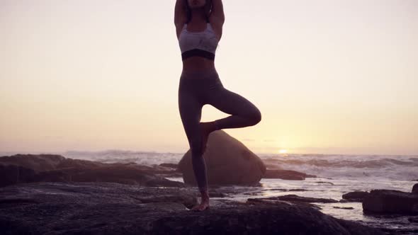 Woman doing yoga on the beach 4k
