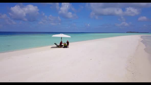 Two lovers posing on exotic tourist beach break by blue ocean and white sandy background of the Mald alt