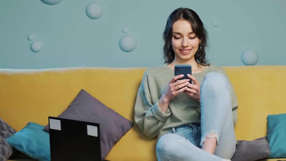 Woman Holding Smartphone and Watching a Funny Video Chating in Social Media alt