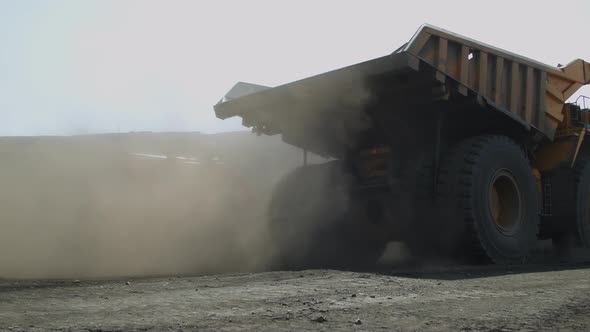 Traffic of Production Vehicles in Coal Mine Crawler Excavator and Crane are Moving Towards Dump