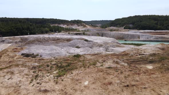 Aerial view quarry extraction porcelain clay, kaolin, with turquoise water