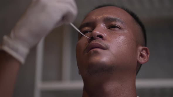 antigen test kit with a COVID-19 2019-nCoV viral disease test kit, people at home performing rapid alt