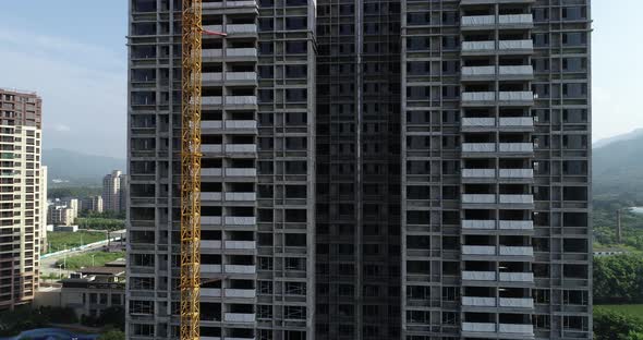 Aerial footage of multistory apartment construction site in China alt