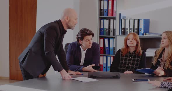 Angry Businessman in Meeting at Office alt