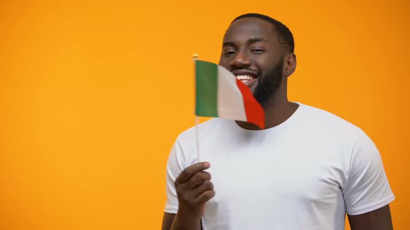 Smiling Afro-American Man Holding Italian Flag alt