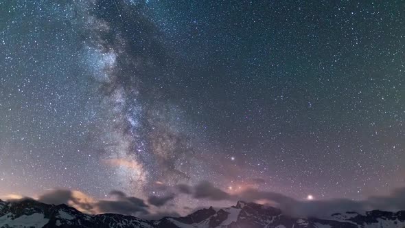 Time Lapse: the Milky way galaxy and stars rotation over the majestic Italian French Alps. Night sky alt