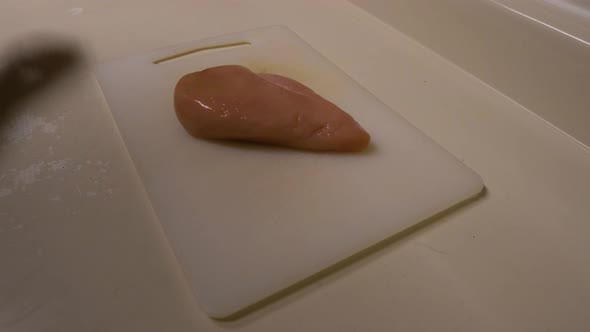 Raw chicken placed on the cutting board ready to be seasoned then BBQ'd alt