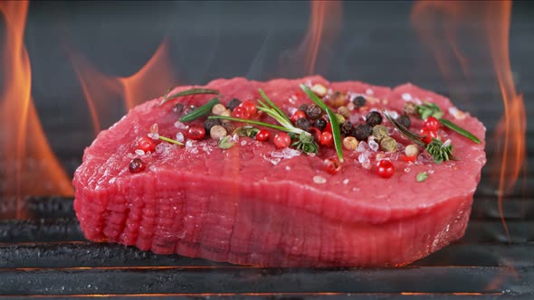 Super Slow Motion Shot of Fresh Beef Meat and Seasoning on Grill at 1000 Fps alt
