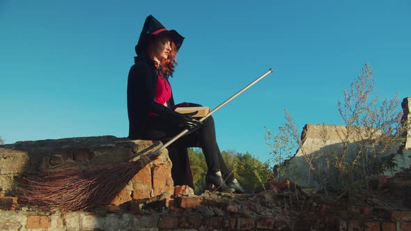 Evil Witch with Spellbook Casting Spells at Sunset alt