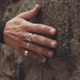 Caucasian hands with silver rings drag along, feeling the stone wall - VideoHive Item for Sale