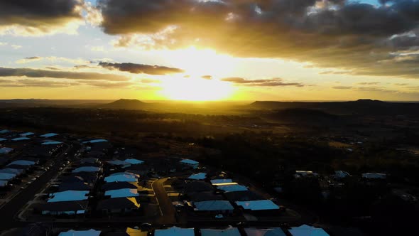 A sunset bathes an estate in its warm glow as the day comes to an end alt