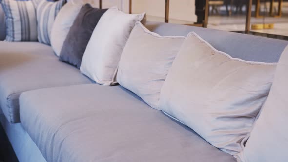 dolly shot of close up sofa beige color fabric pillow cushions luxury home alt