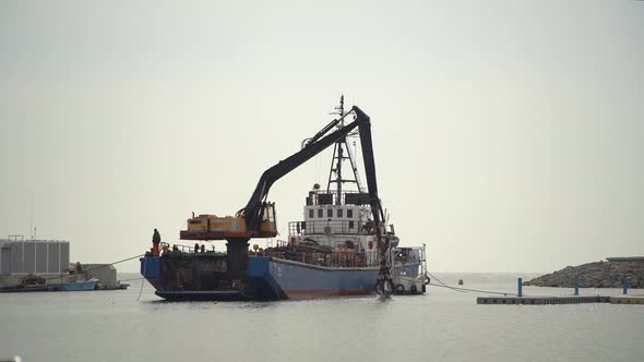 Crane Cargo Stones On The Ship