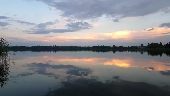 Lake Timelapse. Timelapse Of A Peaceful Lake And Mooving Clouds. Sky And Coluds Over A Lake.