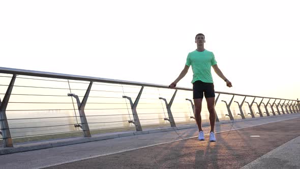 Sportsman Man Jumping on Skipping Rope in Morning Sunrise Jump