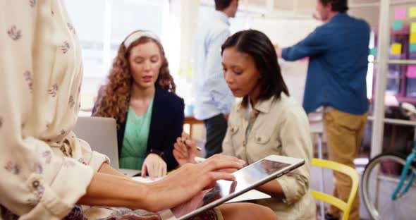 Business executives using mobile phone, digital tablet and laptop alt