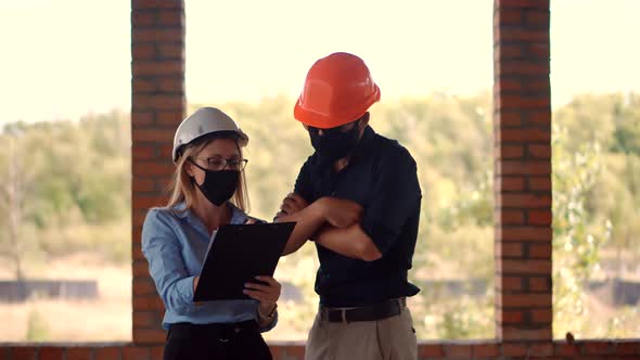 Engineer Architect  In Face Mask Cooperating Working.Engineer In Hard Hat Developing In Lockdown. alt