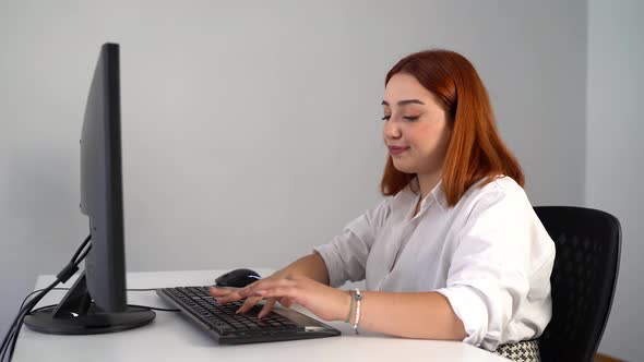 Unhappy Woman Bored Working on Computer in Office 4K alt
