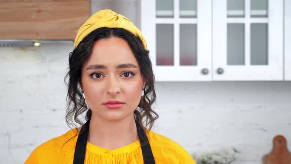 Close Up Sad Beautiful Housewife Looking at Camera in Home Modern Kitchen alt