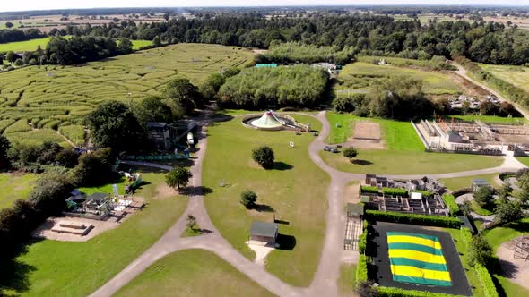 Aerial footage of the fields and country side of the famous York Maze in the UK alt