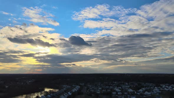 Aerial View of Town Along the River with Residential Areas of Private Houses on Colorful Clouds in alt