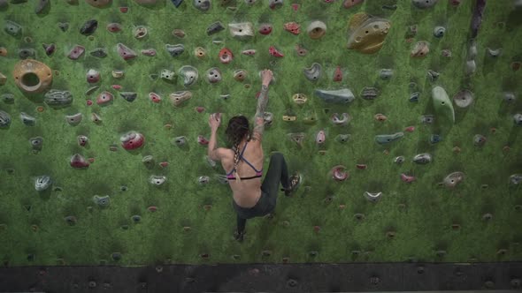 Fitness Professional Woman Arrives at the Artificial Rock Wall and Starts Climbing alt
