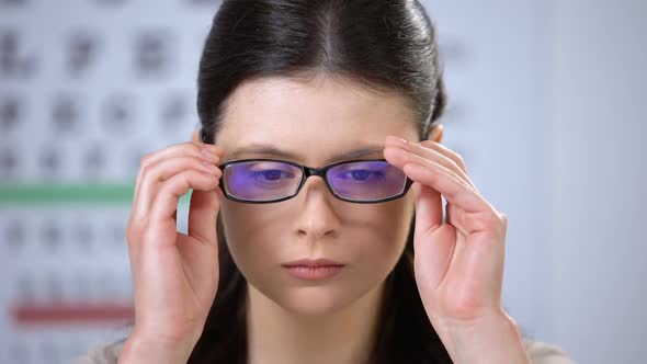 Upset Lady Trying New Eyeglasses and Taking Them Off Depressed With Poor Vision alt