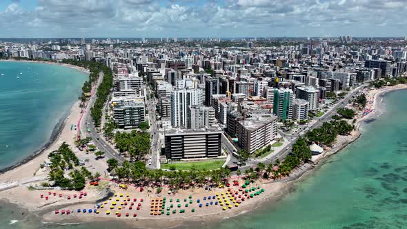 Aerial panning shot of turquoise water beach at Maceio Alagoas Brazil.  alt