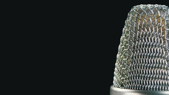 Studio Condenser Microphone Rotates on a Black Background alt