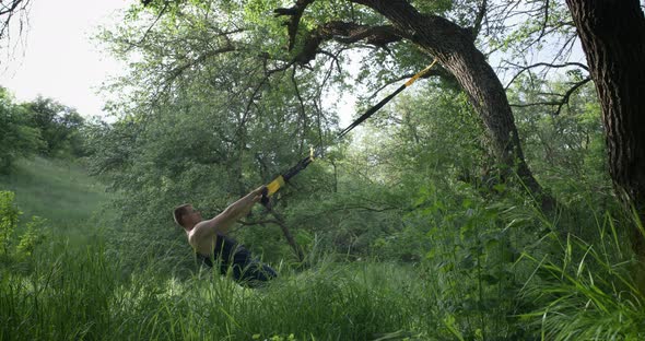 Athletic Man Using Sport Slings alt