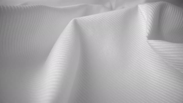 Shiny flowing cloth texture dolly shot in close up view macro shot. alt