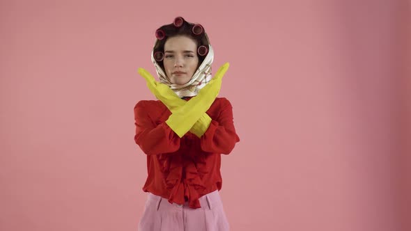 The Cleaning Lady Crosses Her Arms and Makes a Gesture of Prohibition