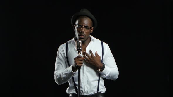 Artist Young Music Recording a Track in the Studio with Music Producer. Black Background alt