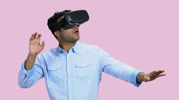 Young Scared Man Wearing Virtual Reality Goggles alt