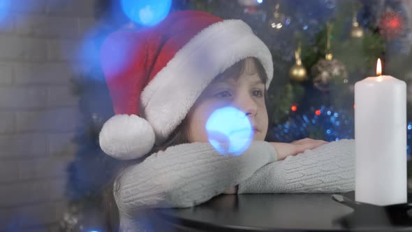 Little Girl Miracle at Christmas Candle at Home alt