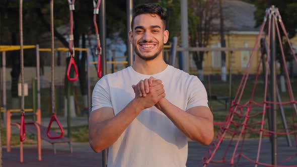 Young Arabic Male Athlete Shows Handshake Gesture Demonstrates Community Support Wishes Success and alt