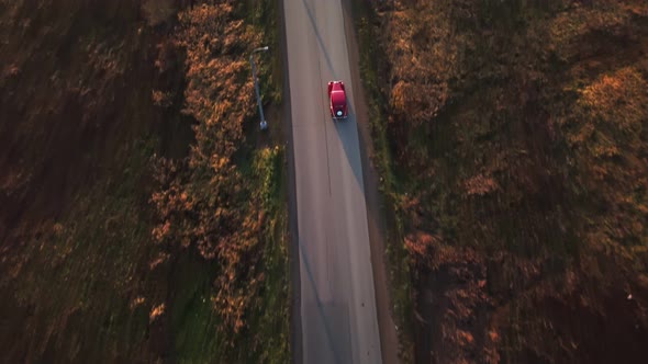 Red Retro Vintage Car Rides on the Road Top View Shooting From a Drone Autumn alt
