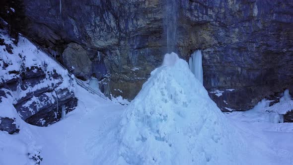 Ascending at Half Frozen Waterfall in Winter