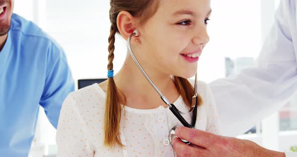 Male doctor examining a patient alt