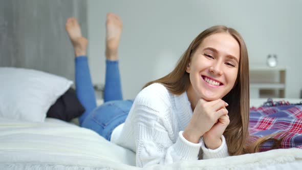 Closeup Face of Happy Girl Having Fun Lying on Bed in Bedroom Enjoying and Relaxing alt